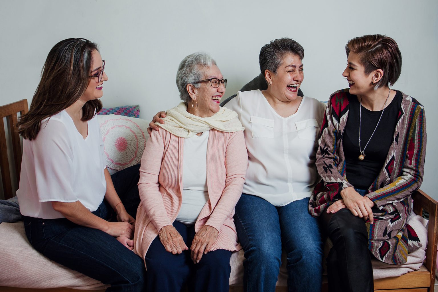 Three generations of Hispanic women on a sofa