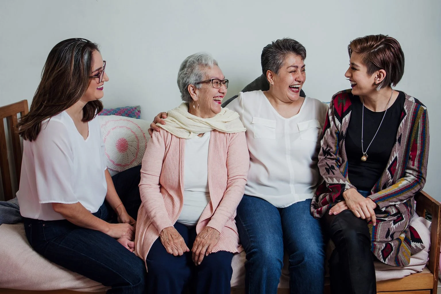 Three generations of Hispanic women on a sofa