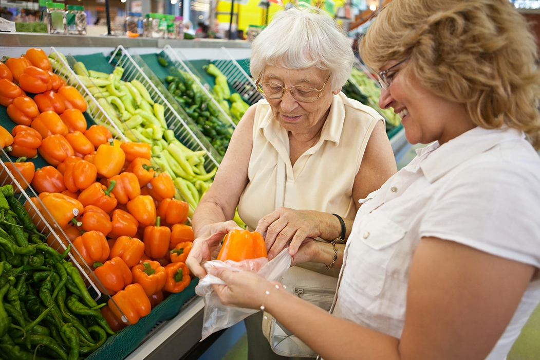 Volunteer lending a helping hand with shopping to a senior