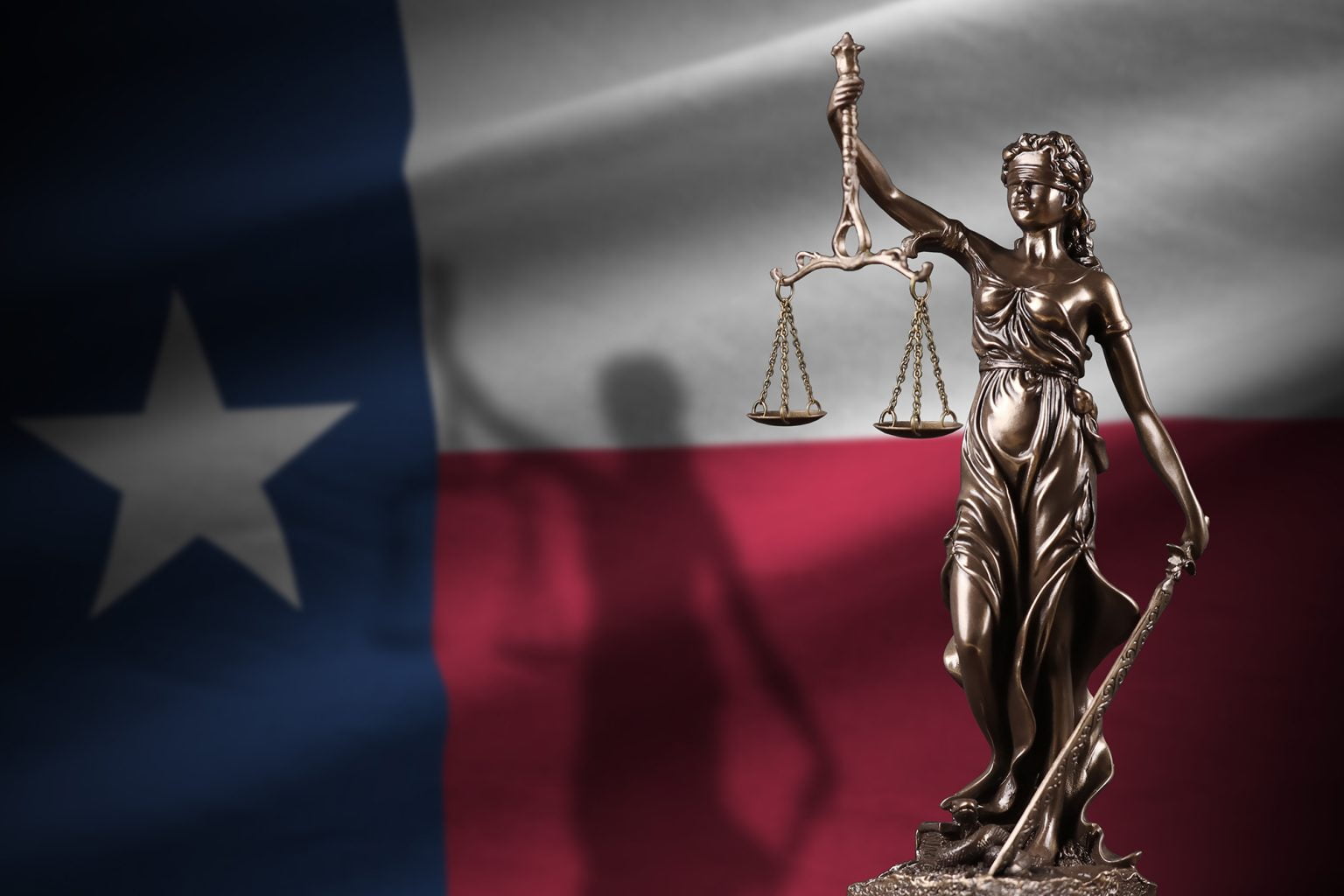 Texas US state flag with statue of lady justice
