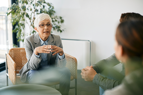 Senior financial advisor having meeting with clients in the office