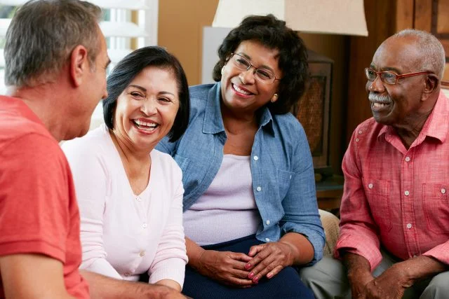 Group of Senior Friends Chatting at Home Together
