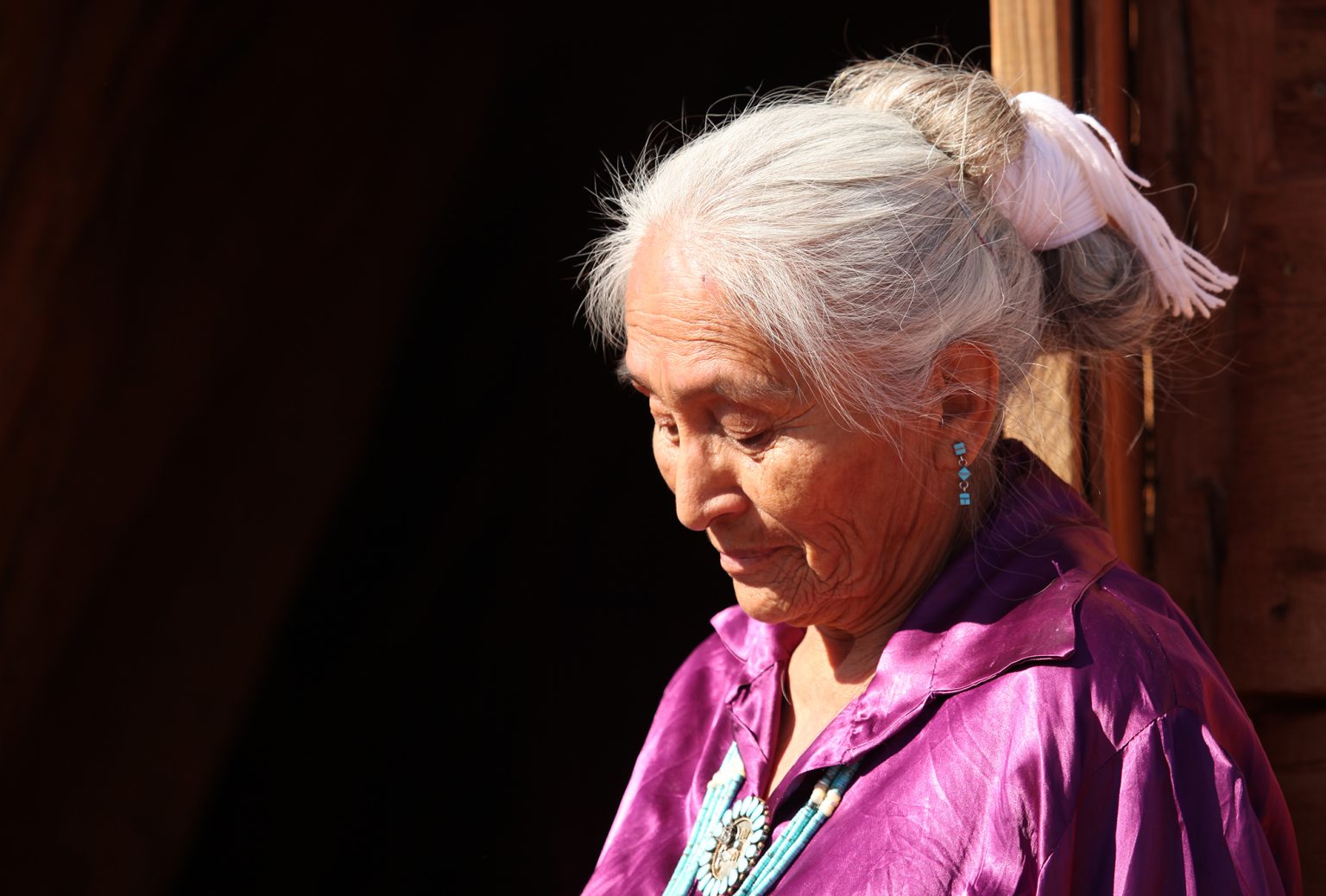 Navajo Woman Looking Down Outdoors in Bright Sun