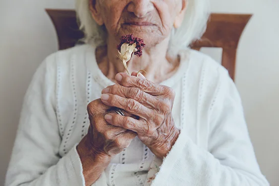 Senior Woman holding a dry flower