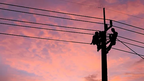 Construction worker on a telephone pole