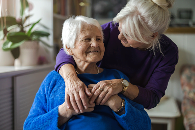 Woman hugging elderly mother