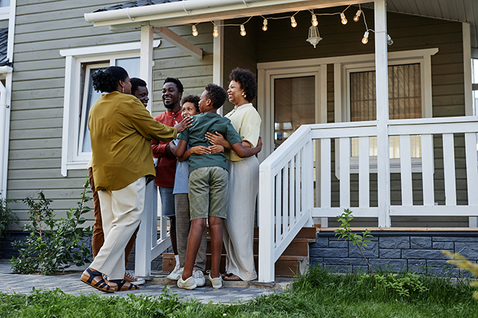 Photo of a Black family visiting their parents