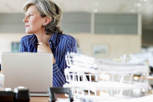 Woman at desk in office, low angle view