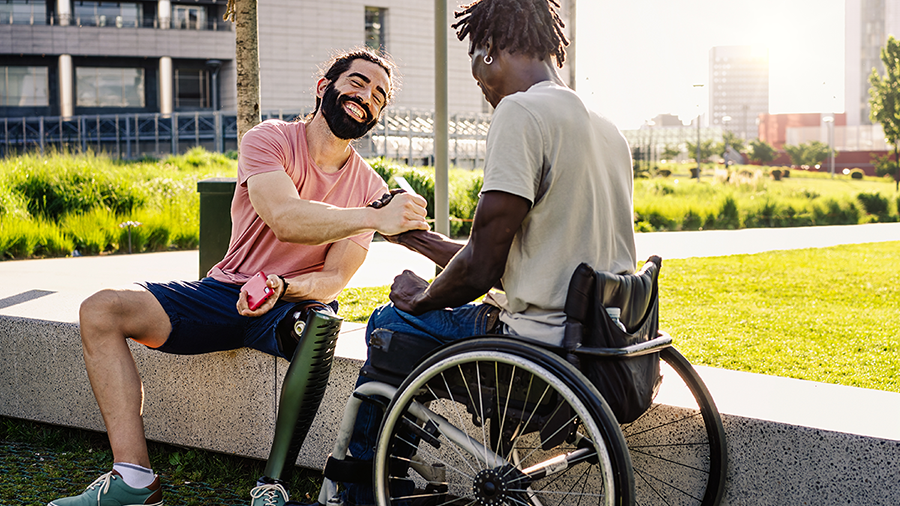 Friends with disabilities shaking hands stock photo