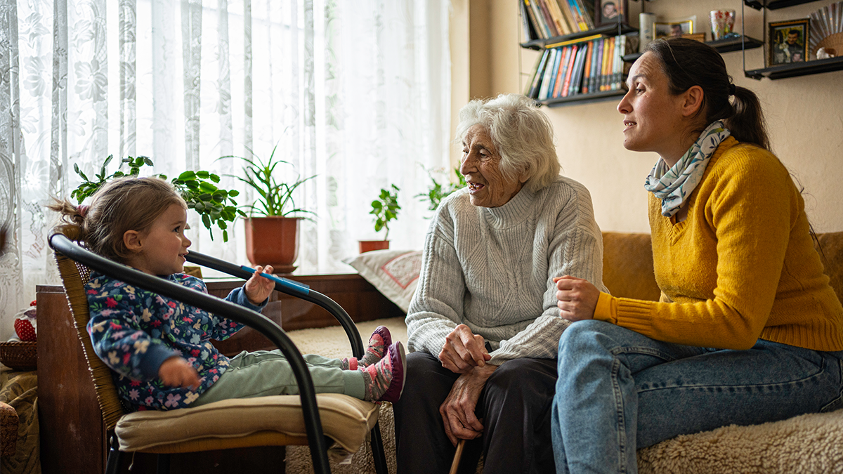 Family get together. Great grandma, mom and girl at home.