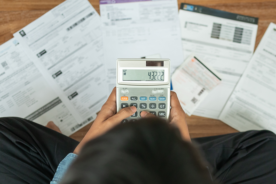 Top view man sitting on the floor stressed and confused by calculate expense from invoice or bill