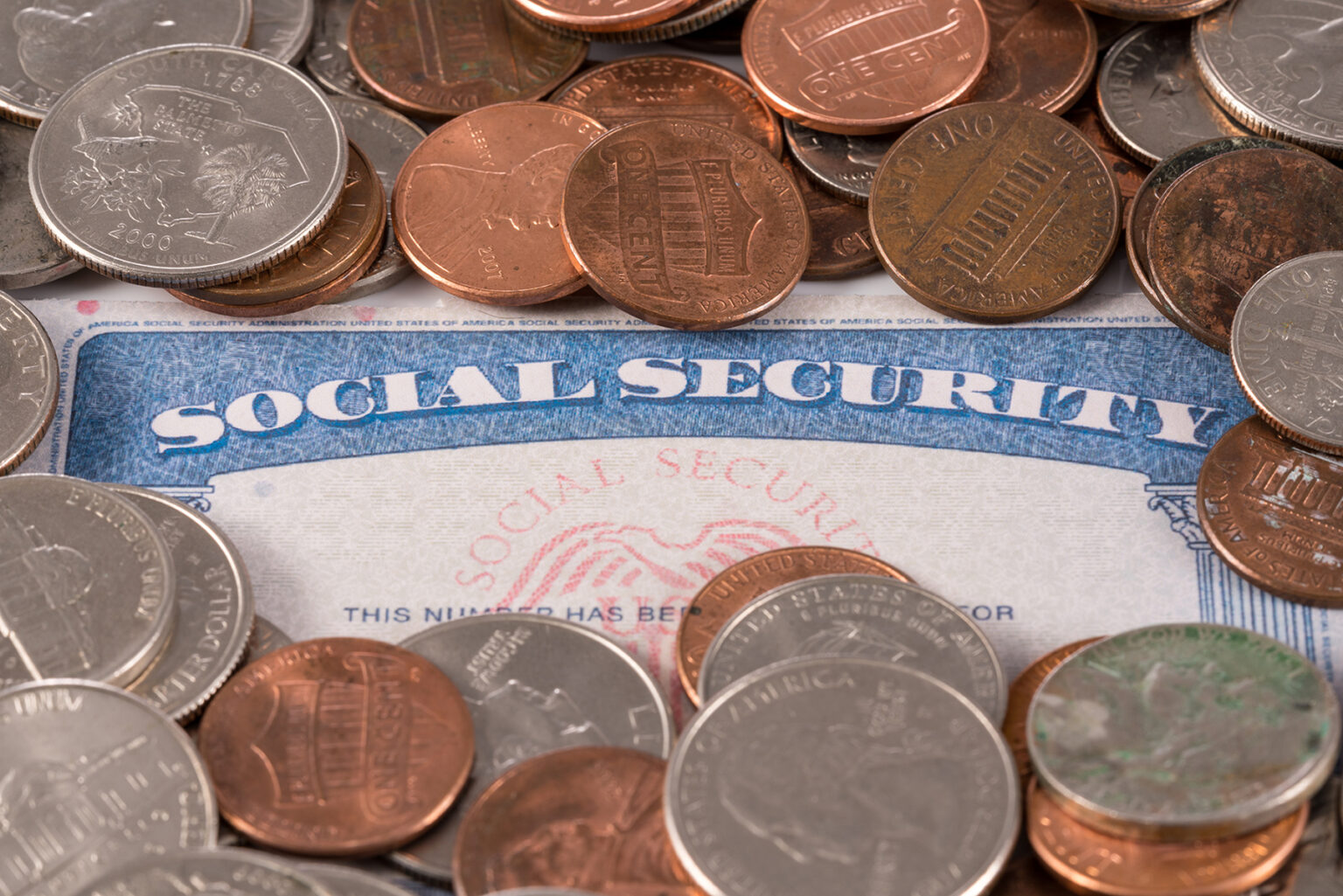 USA social security card overflowing with cash to illustrate budget crisis