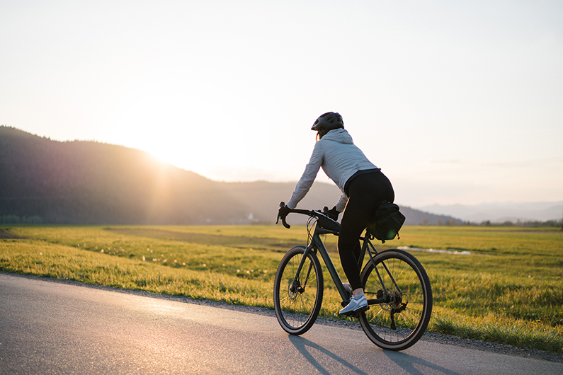 Woman biking down the road