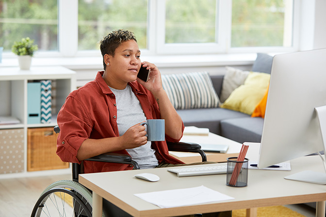 A photo of a disabled person working from home