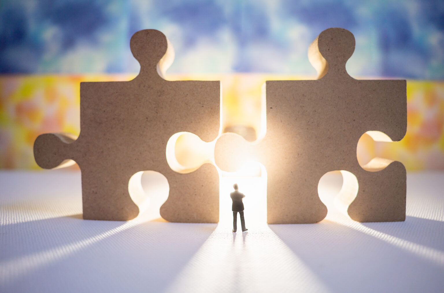 Businessman with wooden jigsaw pieces using as background business partnership concept