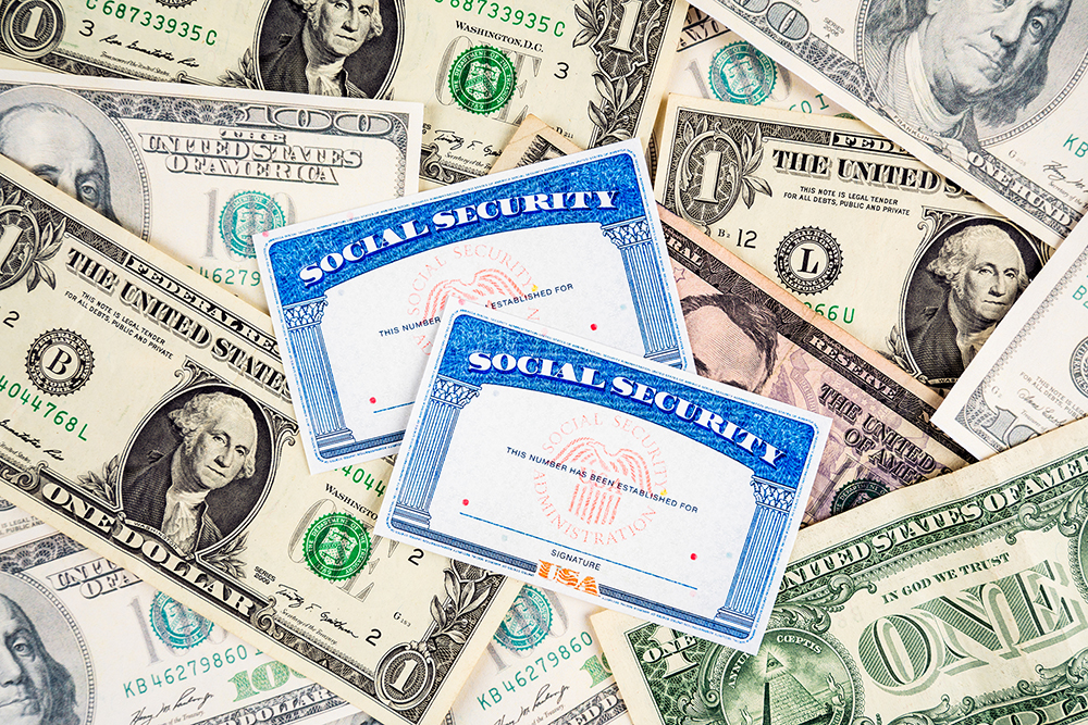 US social security cards and dollar bills