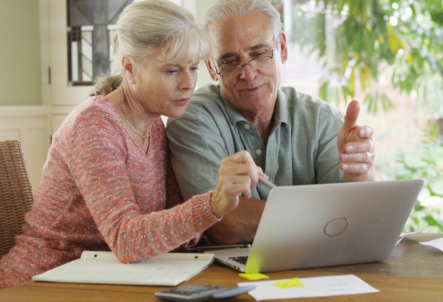 Senior couple using laptop computer to pay bills