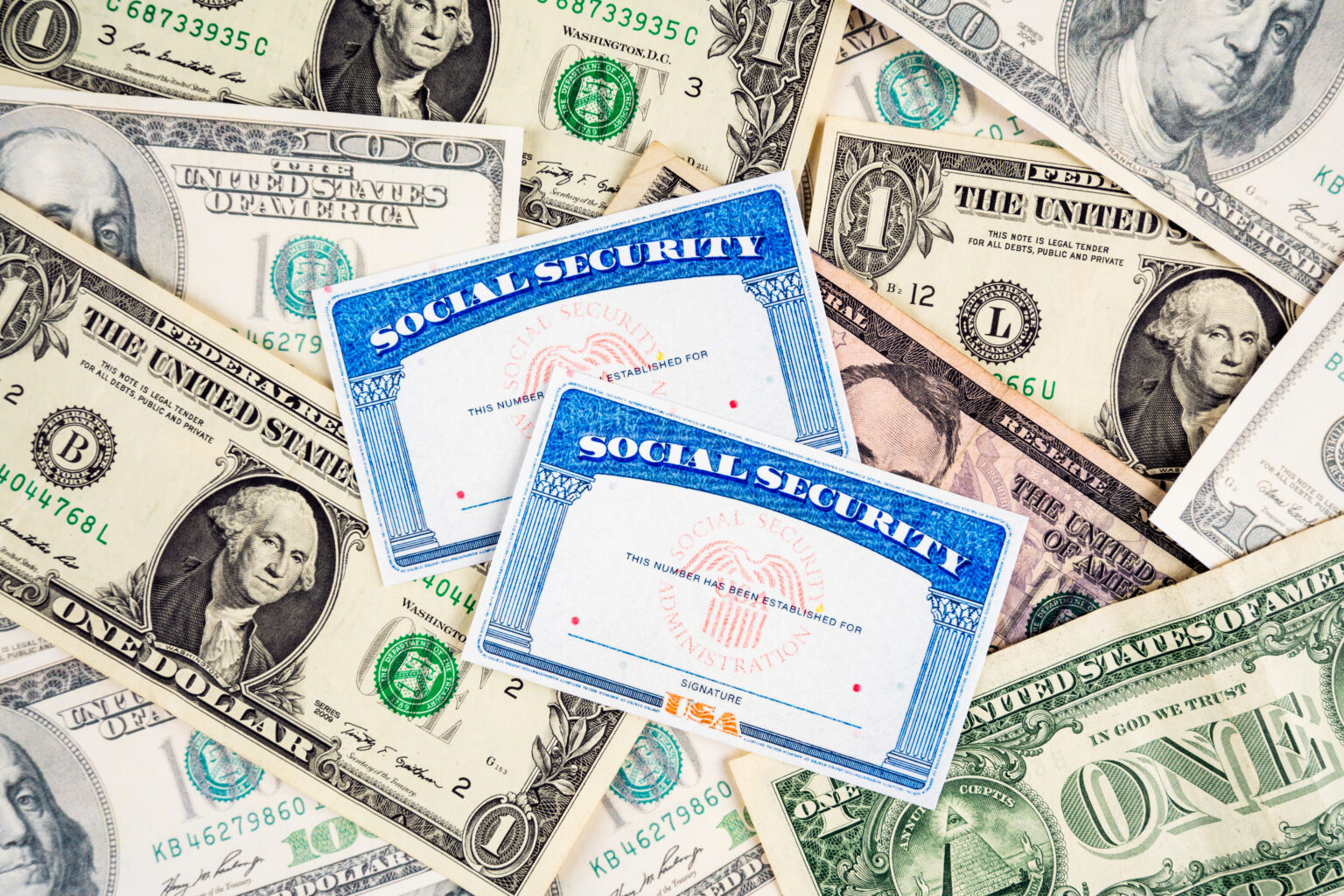 Us social security cards and dollar bills.