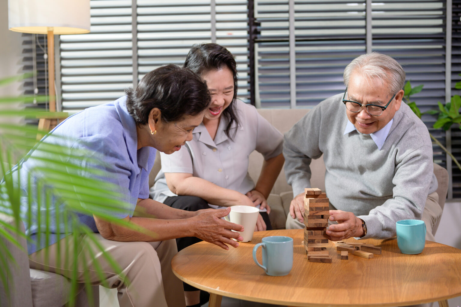 Group of elderly people enjoy talking , relaxing with game at senior healthcare center.