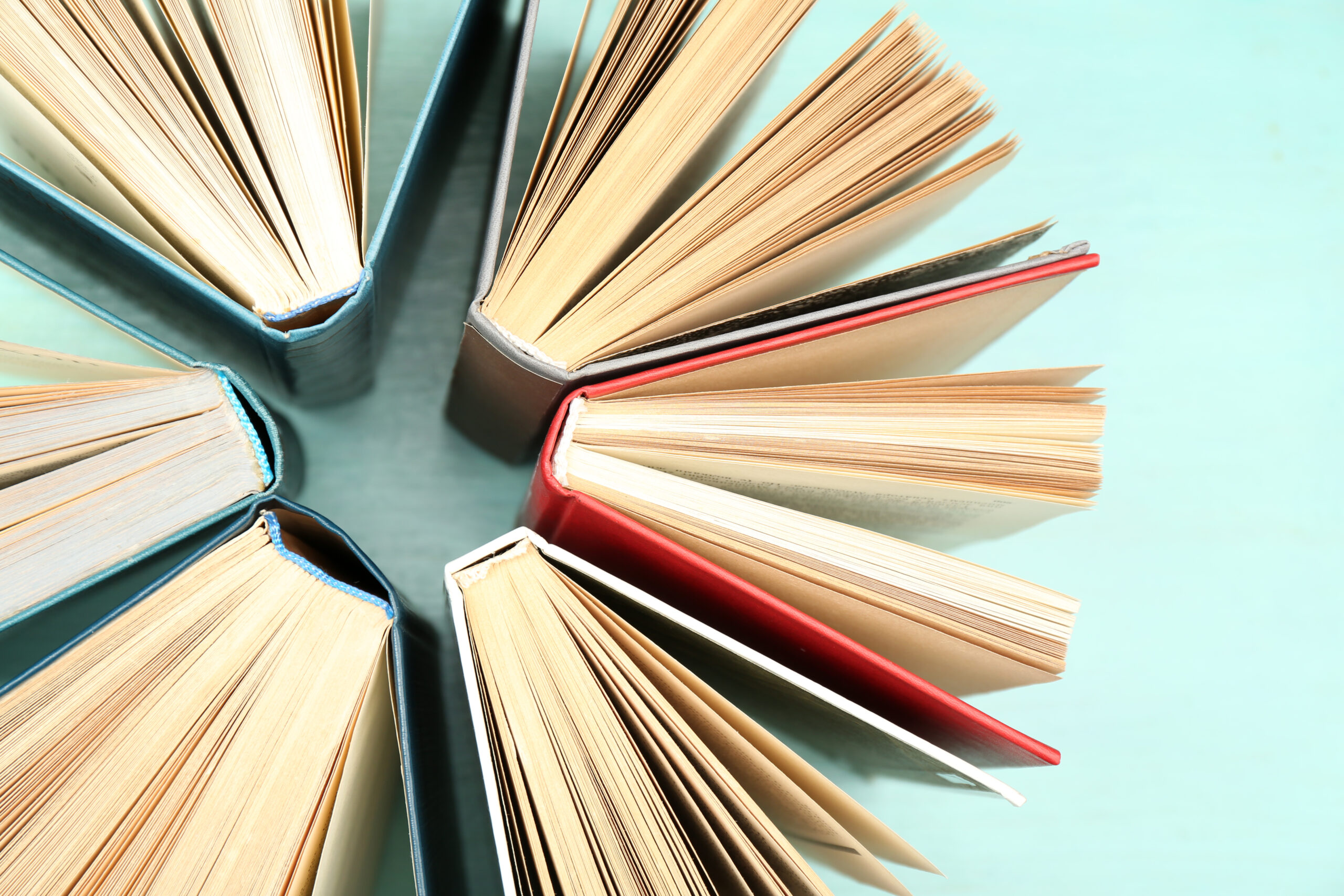 Group of books on colorful background, top view