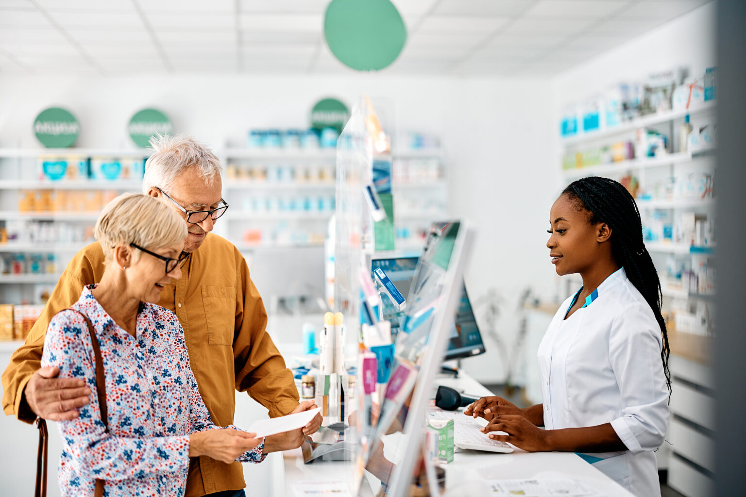Senior couple buying prescription medicine in drugstore