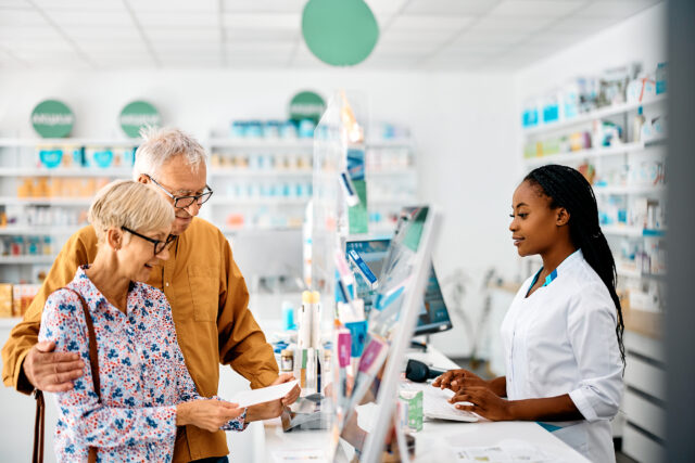 Senior couple buying prescription medicine in drugstore