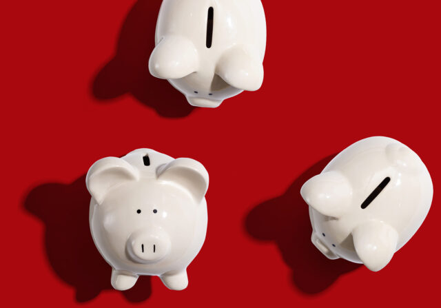 3 white piggy banks on a red background