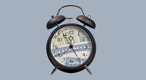 Alarm clock with face replaced by Social Security card and money