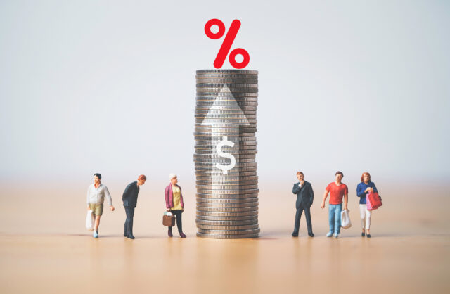 Businessmen and shopper miniature figure standing with high coins stacking , percentage sign , up arrow and dollar symbol